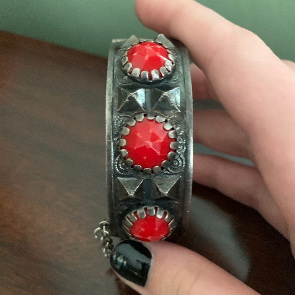 Hinged silver bangle with red glass stones